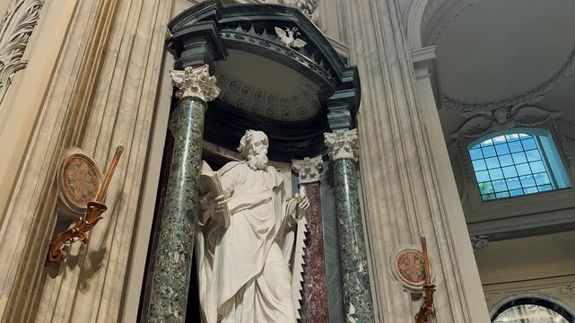 An incredible grand interior view showing the ornate golden ceiling, majestic marble columns, and exquisite religious artwork inside the historic Archbasilica of Saint John Lateran in Rome, Italy.


