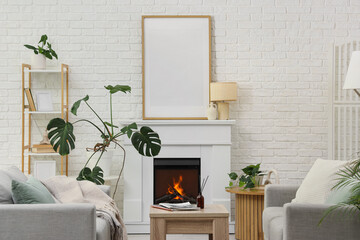 Obraz premium Interior of living room with fireplace, sofas and blank poster