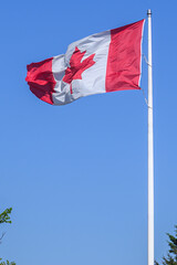 Naklejka premium Waving Canadian flag in Toronto against blue sky