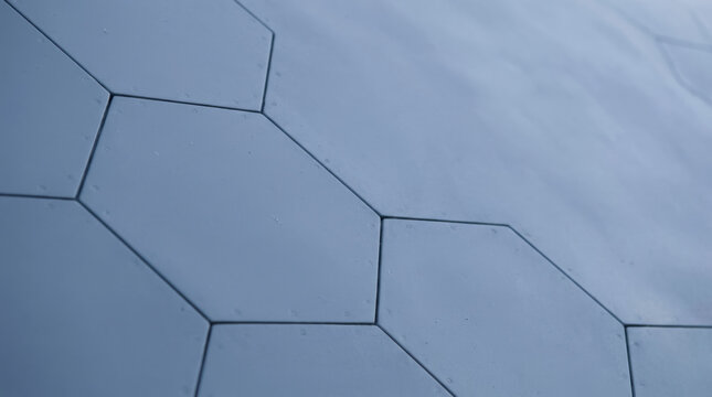 Hexagonal tile pattern with smooth surface and aerodynamic design creates modern and sleek design for architectural or interior use