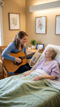 Young woman aged 30 plays guitar for elderly hospital patient