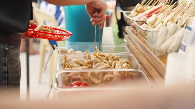 Customer Selecting Tempura and Fish Balls at Street Stall Cebu Philippines