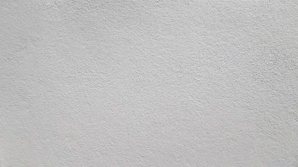 Fotobehang Beton Abstract beige stucco wall texture background with a subtle rough finish and copy space.  © Saminda