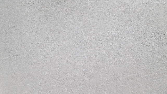 Abstract beige stucco wall texture background with a subtle rough finish and copy space.