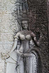 Fototapeta premium Apsara dancer bas-relief carving on the walls of Angkor Wat temple complex, Siem Reap, Cambodia. These celestial dancers are a common motif in Khmer art.