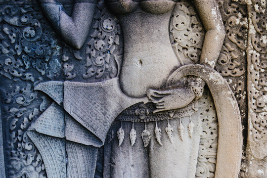 Apsara dancer carving on the walls of Angkor Wat temple complex, Siem Reap, Cambodia. These celestial dancers are a common motif in Khmer art.