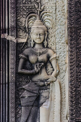 Fototapeta premium Apsara dancer carved in stone at Angkor Wat, Siem Reap, Cambodia. These celestial dancers are a common motif in Khmer art and architecture.