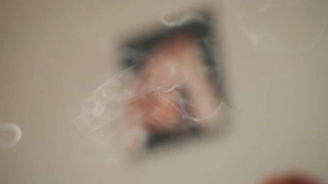 Soft smoke drifting across blurred portrait quiet interior wall, pale tones, looped incense wisps forming rings and curls, cinematic shallow depth, nostalgic shrine vibe with subtle motion, memory