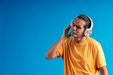 Fototapeta premium Young man experiencing painful loud music listening