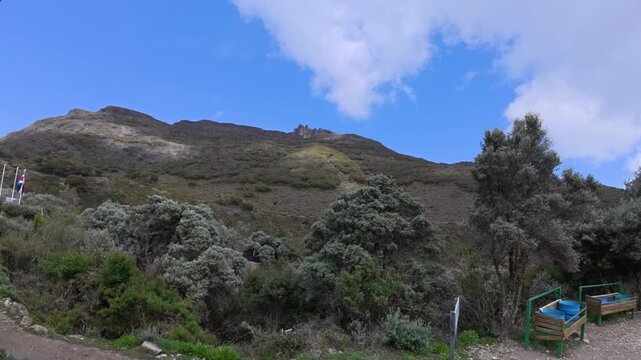 Time lapse of white clouds passing over Los Crestones mountain peak and rock ridges on a sunny afternoon at Chirrip&oacute; National Park, Costa Rica.