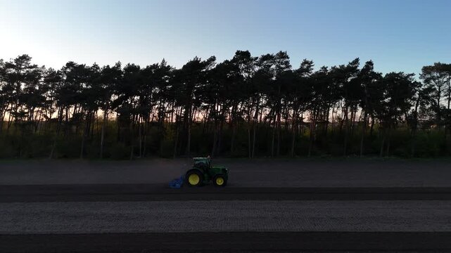 Drone matches speed with tractor plowing agricultural land