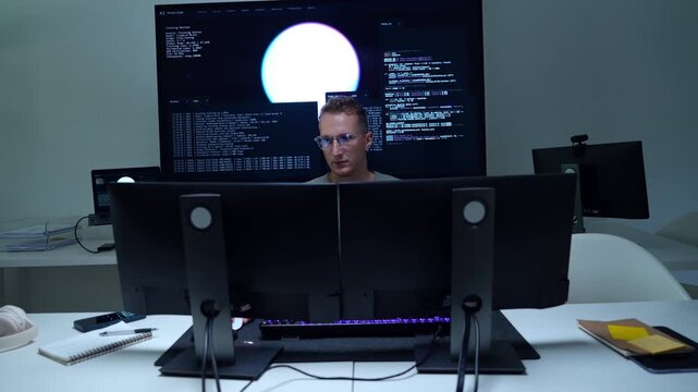 AI developers and technology professionals work at modern office computers, writing software code and analyzing data for artificial intelligence projects.