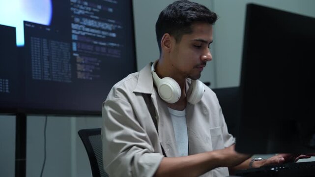 AI developers and technology professionals work at modern office computers, writing software code and analyzing data for artificial intelligence projects.