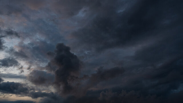 Dark rain cloud dramatic sky summer tropical thunder storm sky and fluffy black darkness cloud nearly raining cloudscape. Dark gray sky cloudy environment. Nimbus raincloud skyline climate background