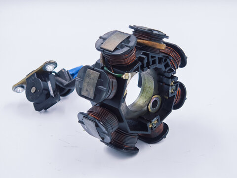 This image shows a motorcycle engine stator coil assembly part, which is an essential component used for generating electricity to power the electrical system.
