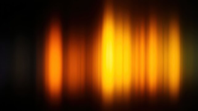 Abstract blurred flames in warm hues of orange and yellow.