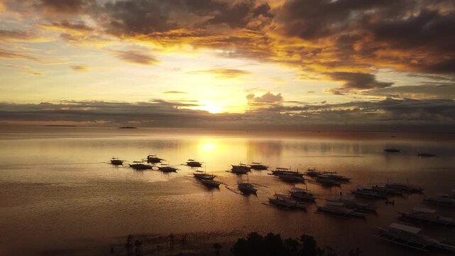 Aerial 4K drone footage of traditional boats at sunset in Panglao, Bohol