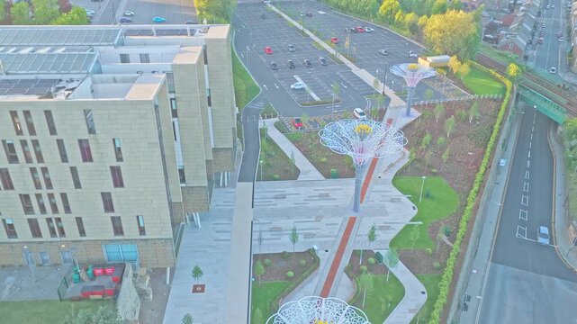 Digital Media Centre and illuminated rose canopy installation in Barnsley town centre, South Yorkshire, England, showing contemporary urban design and regenerated public space, drone ascent tilt down