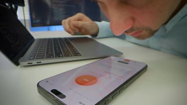 Close-up male developer using artificial intelligence voice assistant application on smartphone displaying active voice session interface. Voice recognition technology, AI chatbot, modern mobile apps.