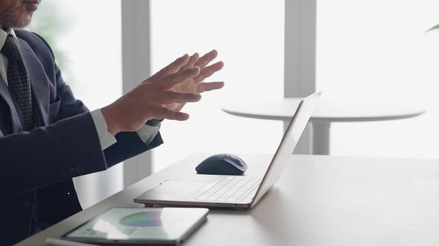 A male businessperson operating a screen in mid-air.
