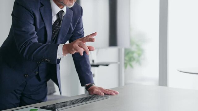 A male businessperson operating a screen in mid-air.