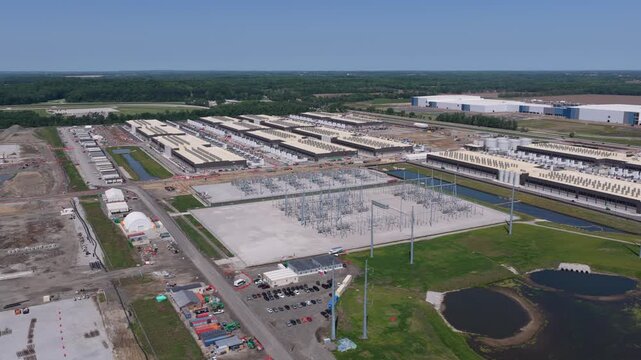 Aerial wide angle view of the construction of data center facility, large AI center structure surrounded by cooling and power back up systems