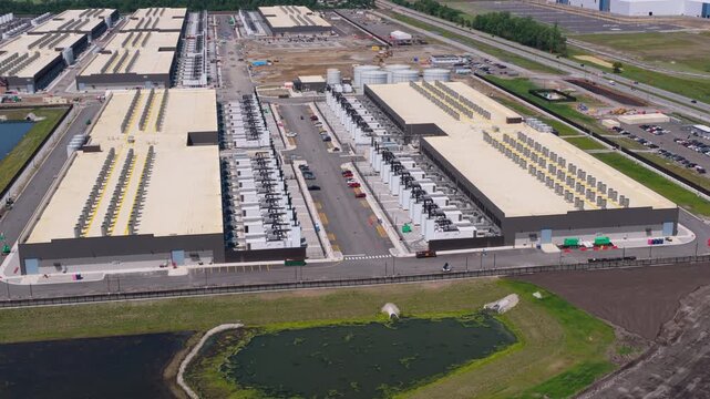 Aerial view of the construction site of data center facility, large AI center  surrounded by power systems