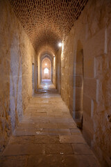 Fototapeta premium Long stone hallway leading to a shooting window on the second level of Qaitbay Citadel in Alexandria, Egypt