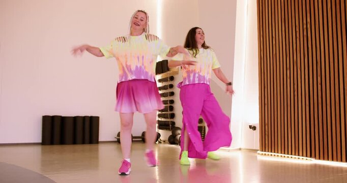 Performer joy. Event dancer. Cheerful woman stepping in energy rhyme in vivid costumes in sport center. Expressive party activity.