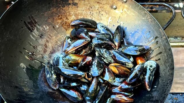 A Batch of Fresh Mussels is Being Cooked in a Pan - Close Up