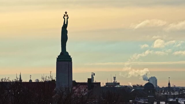 The Freedom Monument, Affectionately Known as Milda, Stands Proudly Above the City Skyline as a Powerful Symbol of Latvian independence in Riga, Latvia - Pan Up Shot