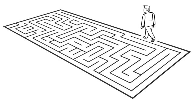 Businessman standing at the entrance of a complex maze pathway