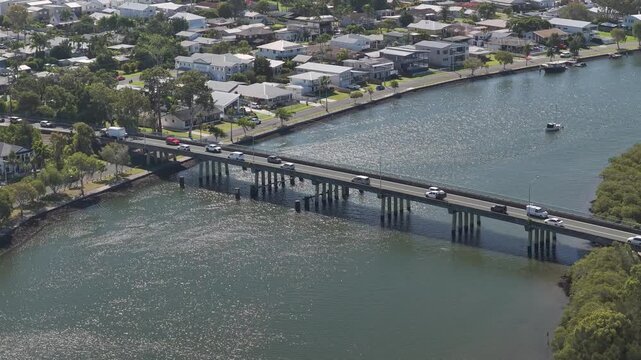Vehicles Driving Along A Bridge In Jabiru Island, Paradise Point, QLD, Australia - Aerial Drone Shot