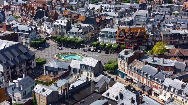 Place Morny fountain and roundabout with traditional Norman architecture in Deauville, France. Aerial drone tilt-up reveal