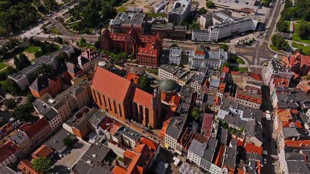 Historic cathedral rising above medieval rooftops in UNESCO Torun center.