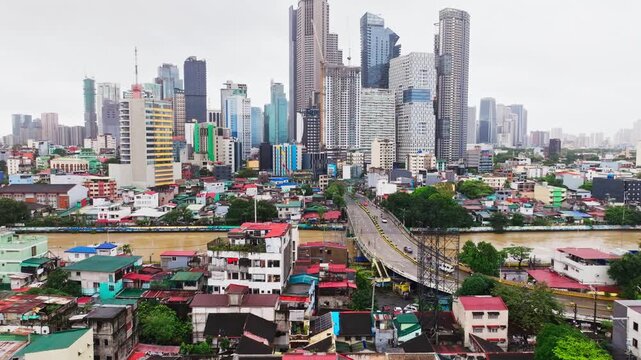 Cloudy skyline rises above Pasig River and dense Metro Manila neighborhoods.