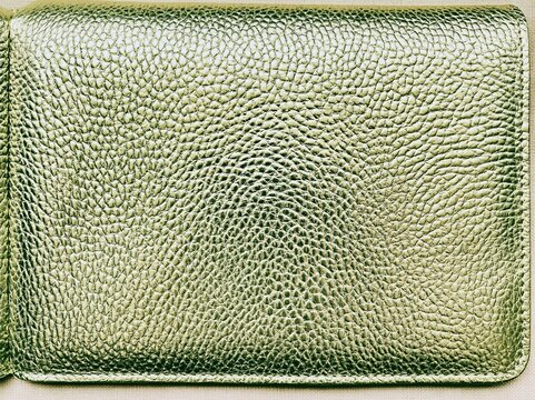 Textured sage green metallic surface with hammered effect for luxury product mockups, elegant interior design backgrounds and premium fashion accessory display