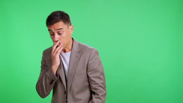 Businessman pretending to whistle nonchalantly on green screen