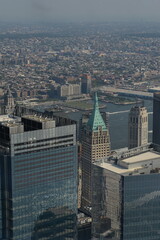 Obraz premium Skyline Of Manhattan With Glass Towers Shining Under Midday Sunlight And Shadows new york