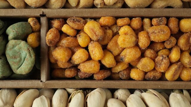 Assortment of roasted nuts and snacks moving slowly