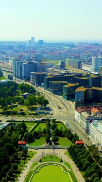 Vertical video. Vienna, Austria. Belvedere Palace, a baroque complex with green copper domes and symmetrical formal gardens, Drone footage over the historic city center under bright summer light. Dro