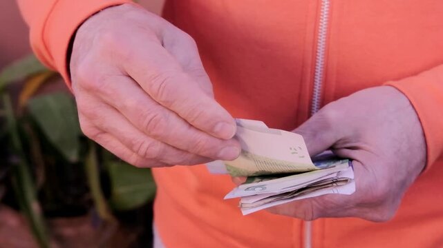 closeup male hands hold Moroccan dirham money, count paper dirham banknotes, concept cash payments, monetary savings, save for vacation, exchange and cashing currency