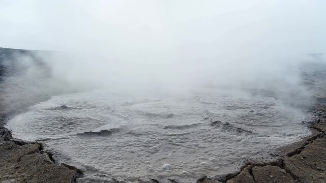 Bubbling Mudpots and Steaming Geysers Erupting in Volcanic Landscape