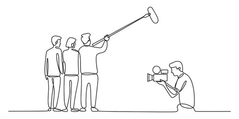Film crew recording a scene with a video camera and a boom microphone © MituRani
