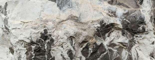Fototapeta premium Rough natural stone rock texture background with grey mineral surface for organic design