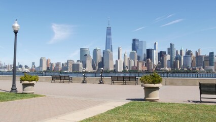 New York City Manhattan Downtown Financial District skyline, World Trade Center tower, cityscape from New Jersey Liberty state park, United States. Hudson river waterfront walkway, skyscraper building © Dogora Sun