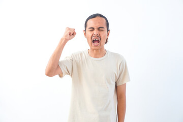 Fototapeta premium Young Asian man in a shirt, with an angry and frustration expression. Isolated on a white background