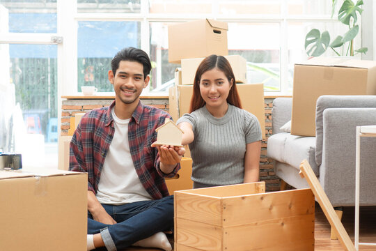 lover couple sitting together after moving in to new house