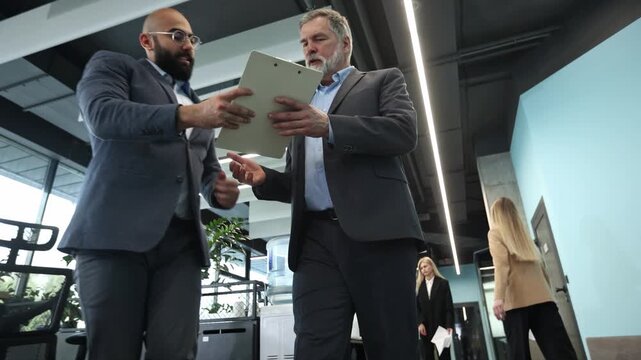 Man and woman in modern office hallway