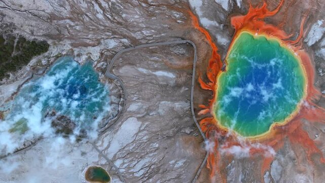 Grand Prismatic Springs pools birdseye aerial drone Mid Geyser Basin Fairy Falls trail boardwalk Wyoming Yellowstone National Park morning colorful hot springs steam nature landscape upwards circle